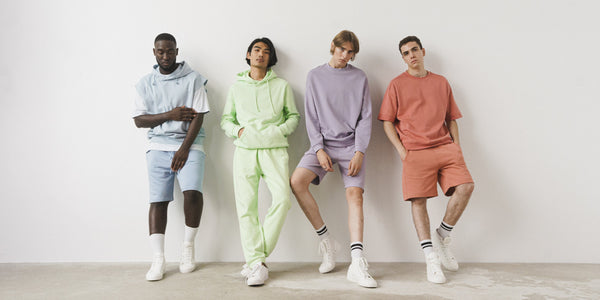 4 men standing wearing co-ord sets.